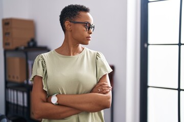 African american woman business worker standing with arms crossed gesture at office