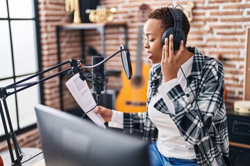 African american woman musician singing song at music studio