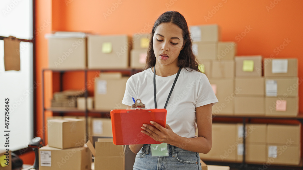 Canvas Prints African american woman ecommerce business worker writing on document checking pacakges at office