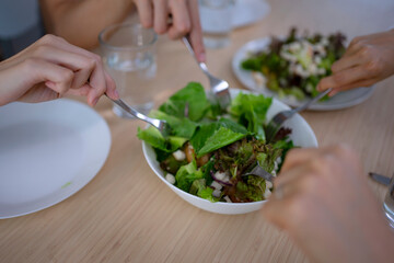 Friends make a meal at kitchen.