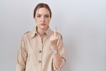 Young caucasian woman wearing casual shirt showing middle finger, impolite and rude fuck off...