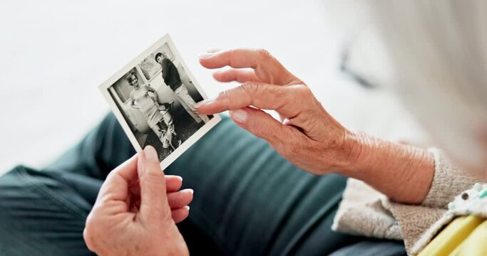 Closeup, home and senior woman with a picture, memory and remember with nostalgia, history and thinking. Hands, elderly lady or pensioner with an image, vintage and retail with photograph in a lounge