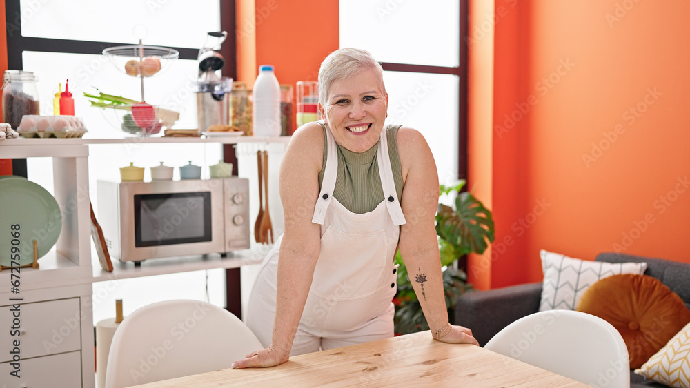 Poster Middle age grey-haired woman smiling confident standing by table at dinning room