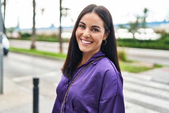 Young beautiful hispanic woman smiling confident standing at street