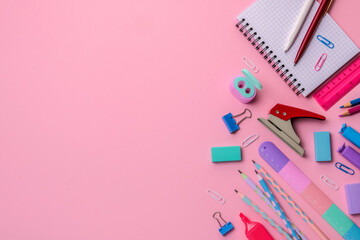 Back to school concept. Stationery on a pink background. Bright stationery in pastel colors for schoolchildren. There is a copy space