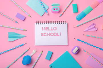 Stationery on a pink background. Bright stationery in pastel colors for schoolchildren. Hello school concept!