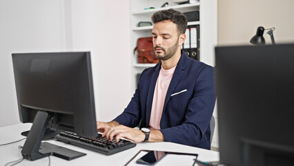 Young hispanic man business worker using computer working at office