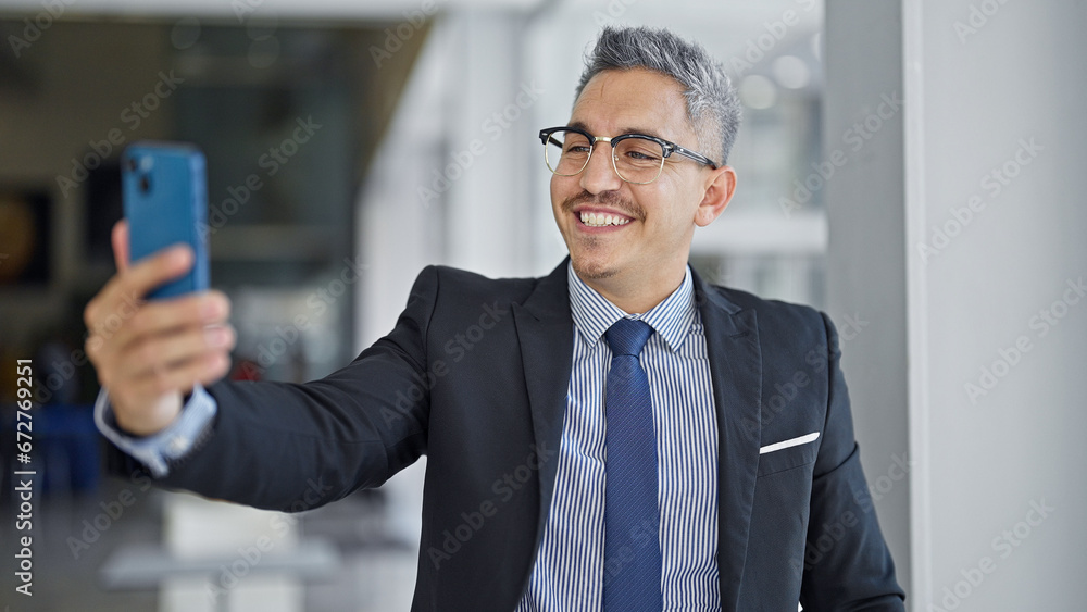 Canvas Prints Young hispanic man business worker smiling confident make selfie by smartphone at office