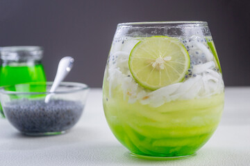 Es Kuwut is a type of Balinese cold cocktail drink made from coconut water mixed with coconut shavings, melon or cucumber shavings, basil seeds, lime juice, melon syrup, ice cubes