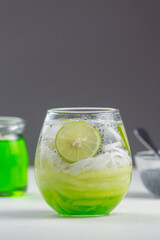 Es Kuwut is a type of Balinese cold cocktail drink made from coconut water mixed with coconut shavings, melon or cucumber shavings, basil seeds, lime juice, melon syrup, ice cubes