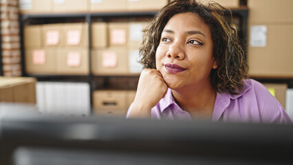 Young beautiful latin woman ecommerce business worker using computer thinking at office