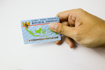 A hand hold or showing an Indonesia identity card or KTP isolated on white background