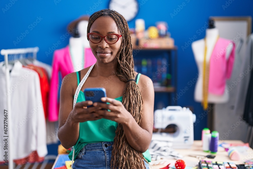 Canvas Prints African american woman tailor smiling confident using smartphone at atelier