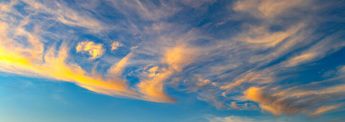 Panorama Clouds sunset are streaks and blue sky.Flushed, fluffy white clouds scatter in full light...