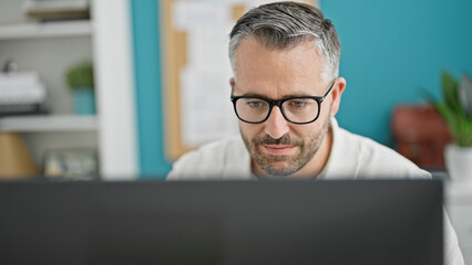 Grey-haired man business worker using computer at the office