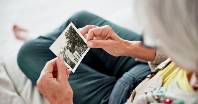 Closeup, home and old woman with a picture, photograph and remember with nostalgia, history and thinking. Hands, elderly lady or pensioner with an image, vintage and retail with memory in a lounge