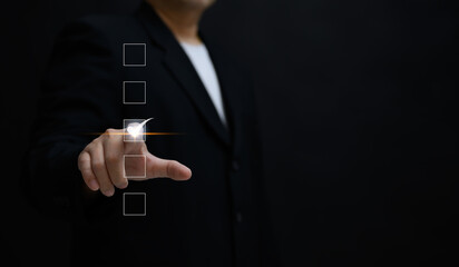 Performance checklist concept : businessman using finger with mobile phone for questionnaire,...