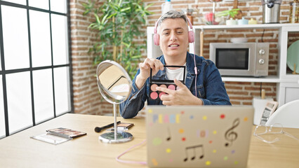 Young caucasian man recording make up video tutorial at dinning room