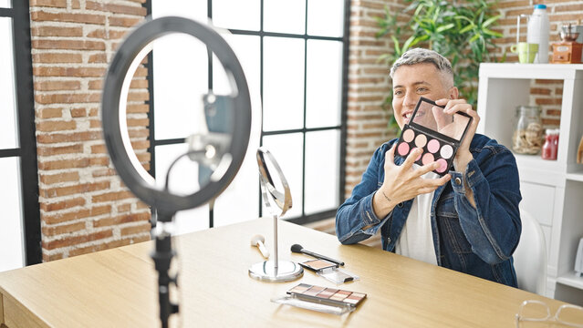 Young caucasian man recording make up video tutorial at dinning room
