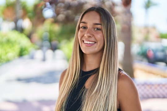 Young beautiful hispanic woman smiling confident standing at park