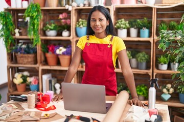 Young beautiful woman florist smiling confident standing at florist