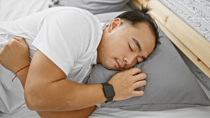 Handsome young chinese man in pajamas, comfortably asleep, tired yet relaxed, lying in the cozy sanctuary of his bedroom, home, a personification of relaxation indoors in the morning.