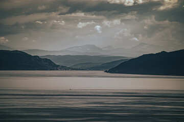 Beautiful view of Trondheim fjord. Rain falling over the sea in Norway.