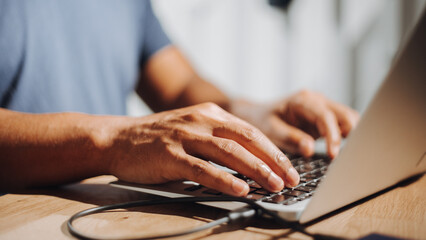 Hands of a cybersecurity professional coordinating a response plan on a laptop during a security...