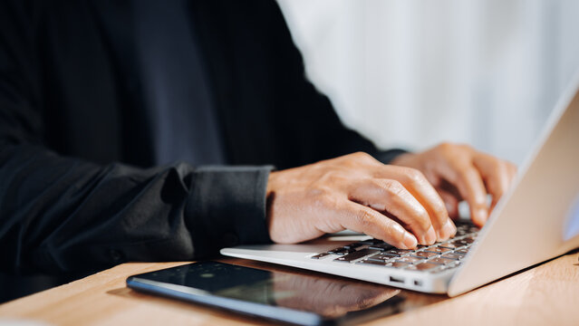 Hands holding a laptop displaying cybersecurity tips and advice, promoting awareness and education.
