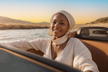 Young Woman with is happy and enjoys ride in cabrio car along coast sea. active, confident and happy woman - obrazy, fototapety, plakaty
