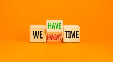 We have or not time symbol. Concept word We have or have not time on beautiful wooden cubes. Beautiful orange table orange background. Business and we have or not time concept. Copy space.