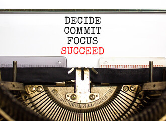 Decide commit focus succeed symbol. Concept word Decide Commit Focus Succeed typed on old retro typewriter. Beautiful white paper background. Business decide commit focus succeed concept. Copy space.