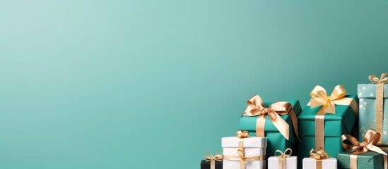 Banner with many gift boxes tied velvet ribbons and paper decorations on Green background. Christmas background, copy space - obrazy, fototapety, plakaty