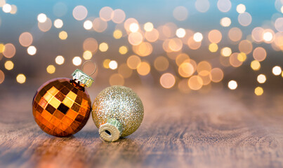 Christmas Baubles on wooden table and defocused lights in the background. Copy Space