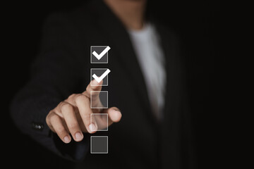 Businessman ticks checklist and takes online assessment survey test for approve business project....