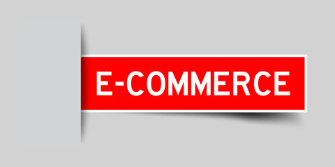 Inserted red color label sticker with word e-commerce on gray background