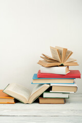 Open book, hardback colorful books on wooden table. Back to school. Copy space for text. Education business concept.