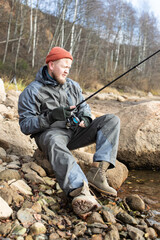 fisherman fishing on the river bank