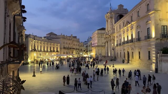 Duomo di Siracusa Evening city, tourists strolling around Ortigia. Central square of Syracuse. Italy October 2, 2023.