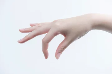 Fotobehang 指先で摘む女性の手（下向き） © guttyphoto