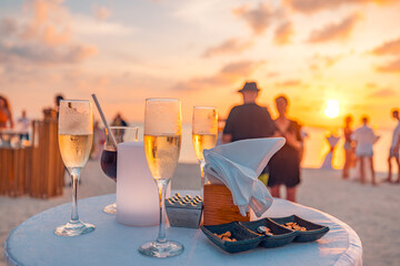 Sunset sunlight closeup glasses of champagne in a restaurant on the coast of a resort in the...