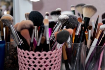 Selection of makeup brushes arranged in a stylish holder