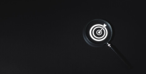 Business concept, business strategy, magnifying glass and target icon, black background