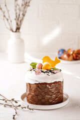 Easter, Easter cupcake decorated with bird and chocolate eggs, 0 degree view, light background with willow branches near painted eggs, close up, 