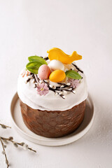 Easter, Easter cake decorated with bird and chocolate eggs, 45 degree view, light background, close-up