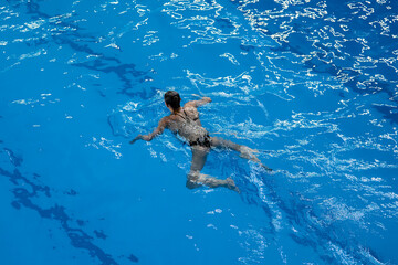 female swimmer is engaged in sports swimming in the pool, international competition