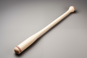 A wooden baseball bat sitting on a wooden table.