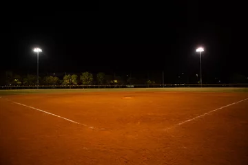 Fotobehang Empty baseball field at night, view from home plate © catahula