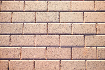 Outdoor brick walkway in light brown, horizontal background texture