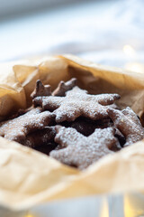 Gingerbread cookies sprinkled with powdered sugar in a box